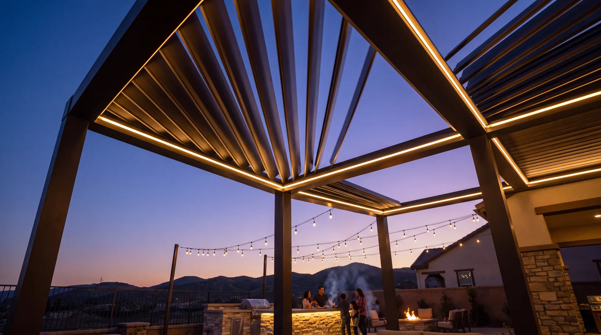 An illuminated patio cover with motorized louvers closing against a dusk sky