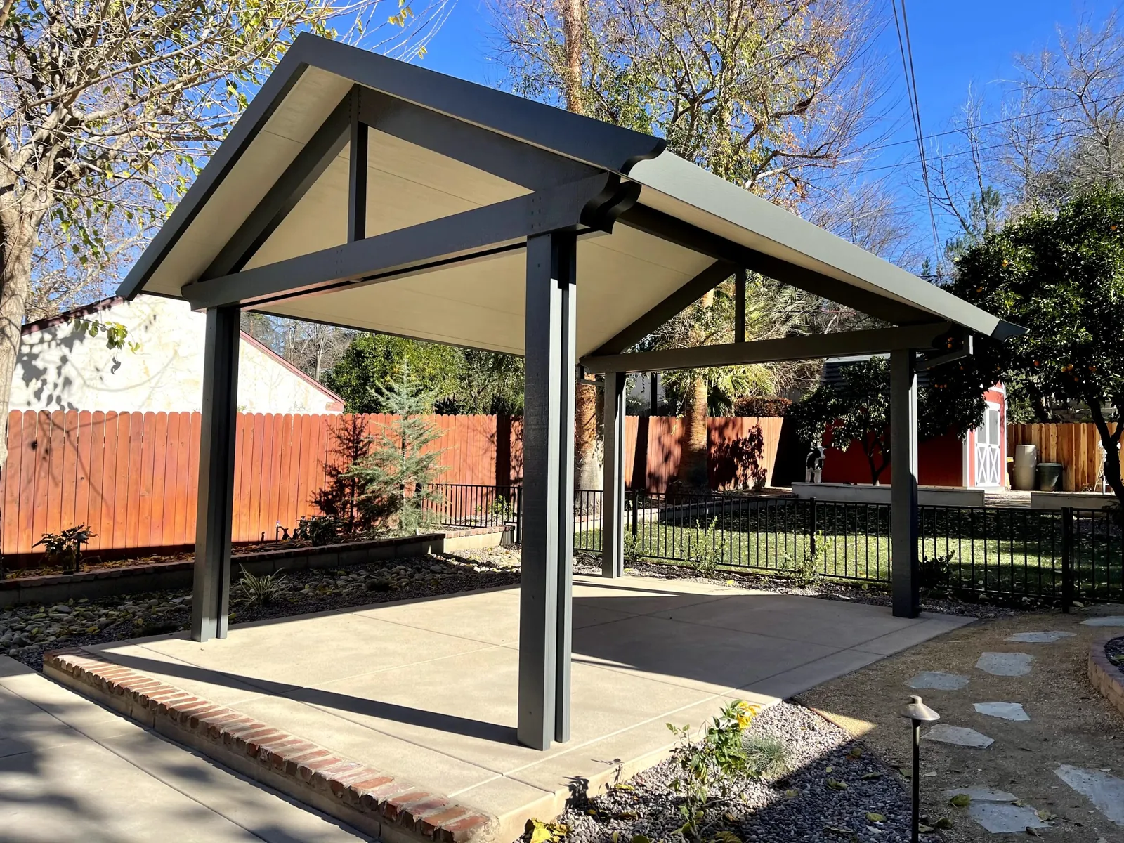 Gable patio cover over a residential backyard patio