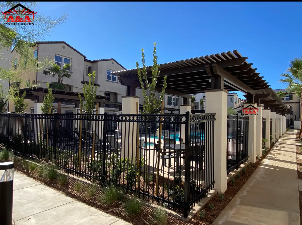 Pergola shade structure beside a community pool at a multi-family residential property