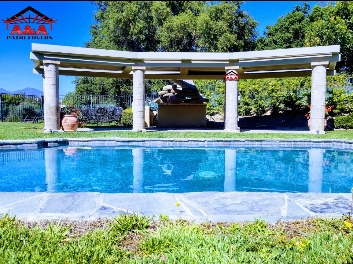 White column pergola with a lattice roof beside a residential swimming pool