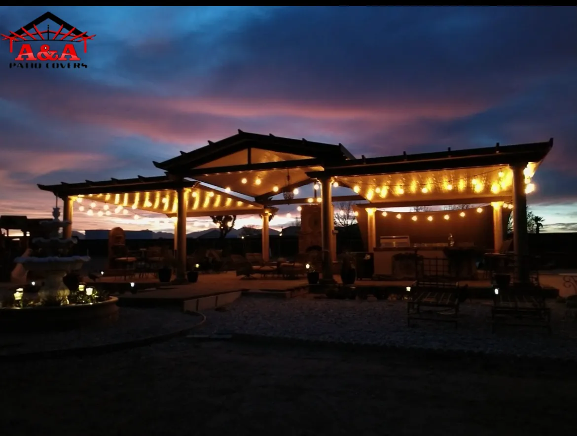 Large pergola lit with string lights against a sunset sky